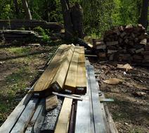 A pile of wood sitting on top of a wooden deck.